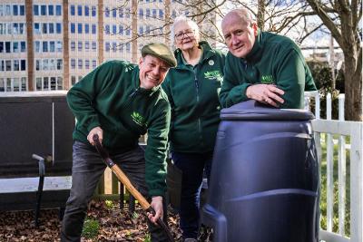 Three master composters next to a compost bin