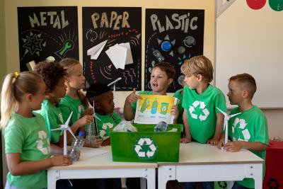Children in a classroom learning and discussing recycling